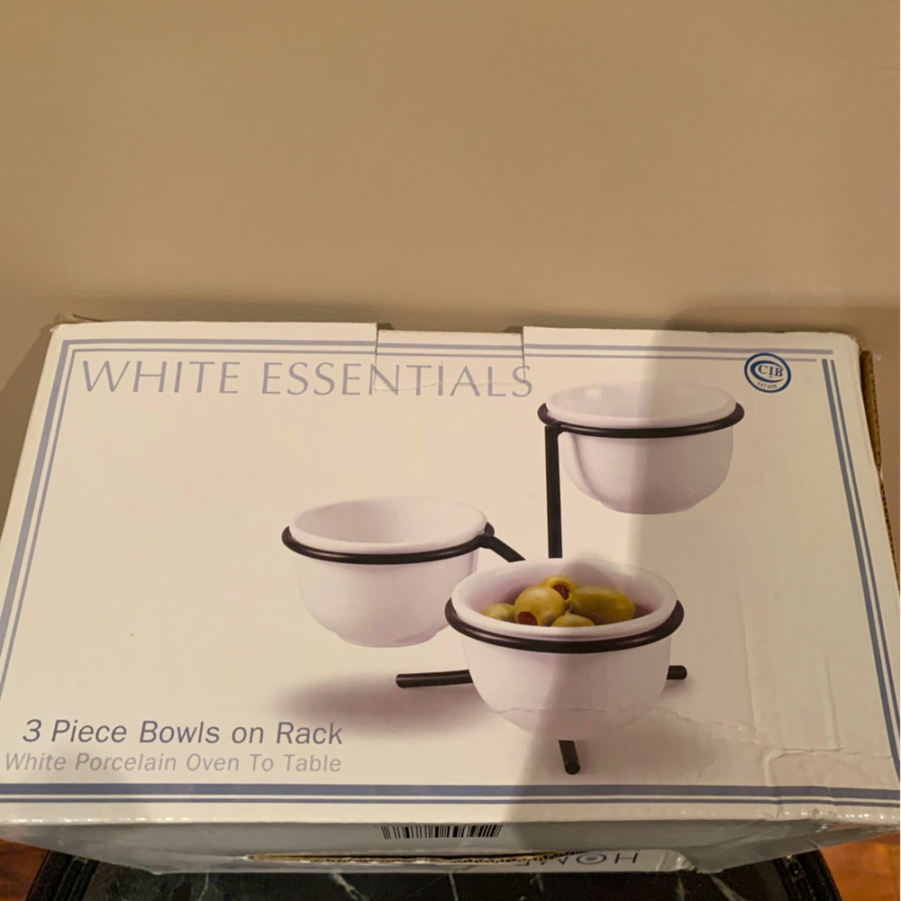 3  white porcelain  bowls with rack .
